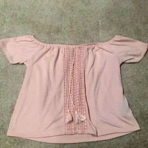 A baby pink off the shoulder top